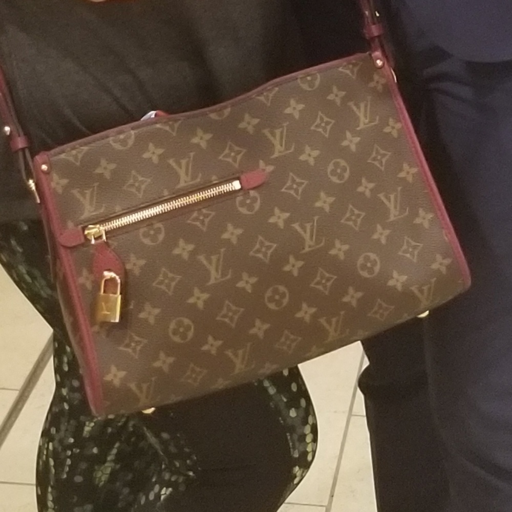 Loui Vitton handbag with crossover strap.